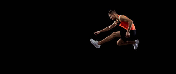 istock Young man, male athlete in motion isolated over black studio background. Side view 1341474131
