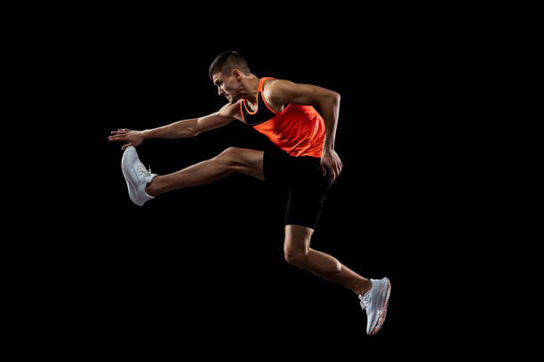 istock Young man, male athlete in motion isolated over black studio background. Side view 1341474132