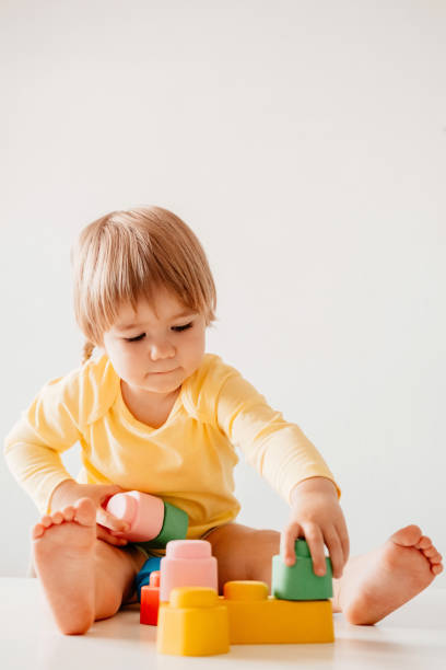 istock Little girl playing, sitting at the table 1341475233