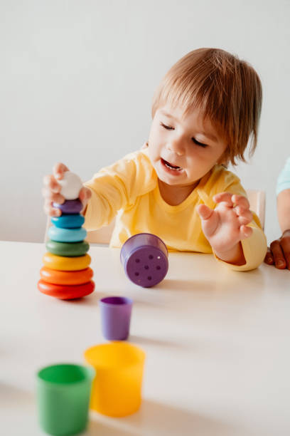 istock Little girl playing, sitting at the table 1341475242