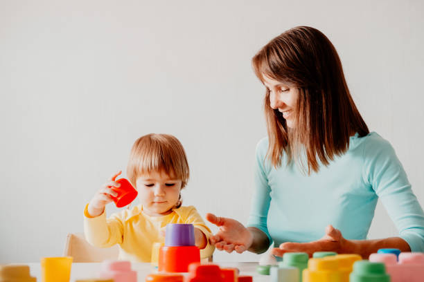 istock Mother and daughter playing together 1341475245