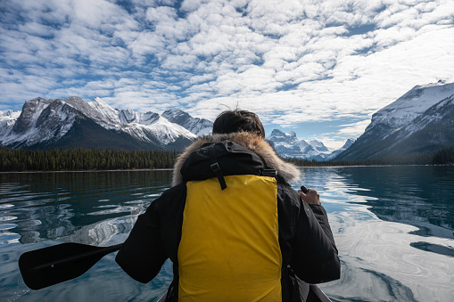 Traveler man canoeing with Canadian Rockies on Maligne lake at Jasper national park, AB, Canada