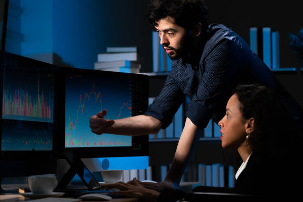 istock Two businessmen, wearing earrings, checking, discussing information on the computer concept finance, marketing, agreement, consent, acceptance, part-time work, night work 1341477528