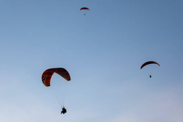 istock 3 paragliders in a symmetrical triangle shape in the air 1341477898