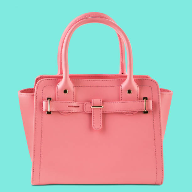 istock pink womens bag with handles, on a turquoise background, frontal arrangement 1341478011