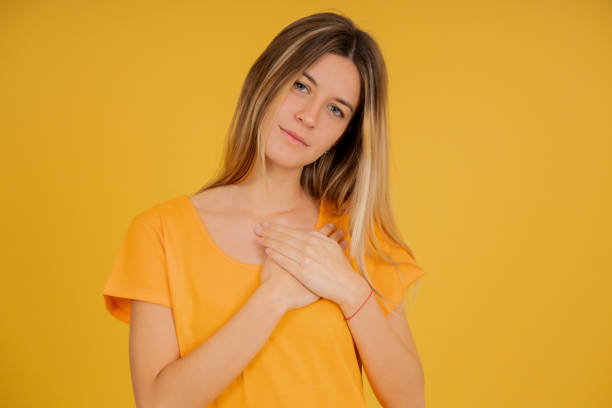 istock Young woman putting hands on her chest expressing gratitude. 1341478894
