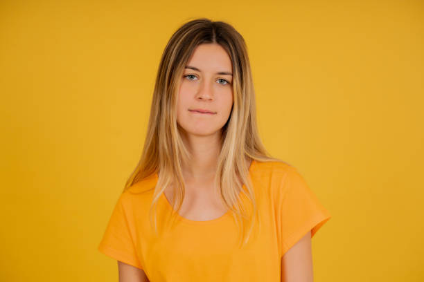 istock Young bored woman standing on an isolated background. 1341478901