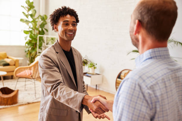 istock Two diverse businessmen shaking hands and smiling in an office 1341479293
