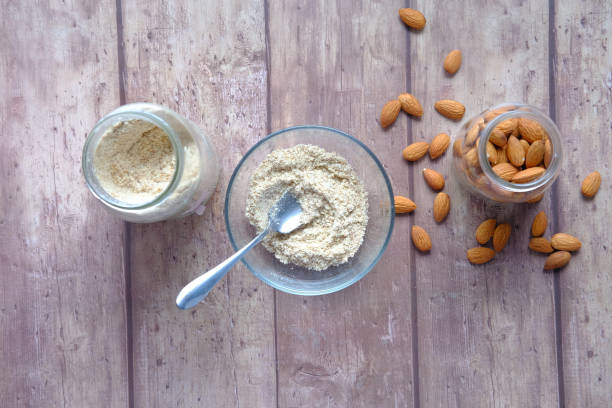 istock almond powder and almond in a jar on table, 1341479303