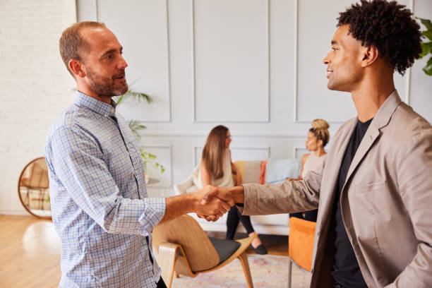 istock Diverse businessmen greeting each other with a handshake in an office 1341480739