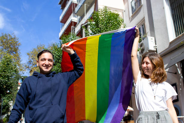 istock men and women hold lgbtqi flag 1341481132