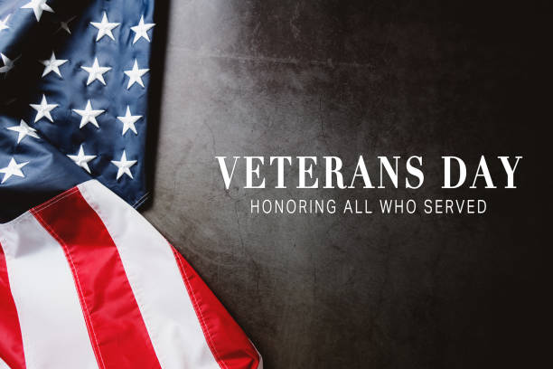 Veterans day. Honoring all who served. American flag on gray background with copy space. Veterans day. Honoring all who served. American flag on gray background with copy space. veterans day stock pictures, royalty-free photos & images