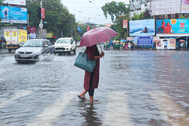hardship faced by office going people after a torrential rain flooded most part of city - shower women water outdoors imagens e fotografias de stock