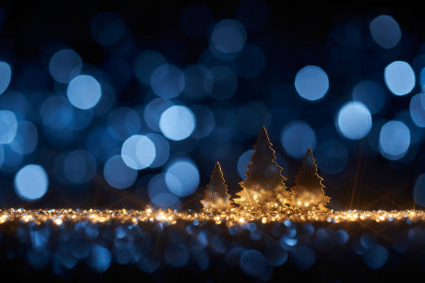 istock Shiny golden Christmas trees background- Defocused Gold Blue Bokeh 1341484676