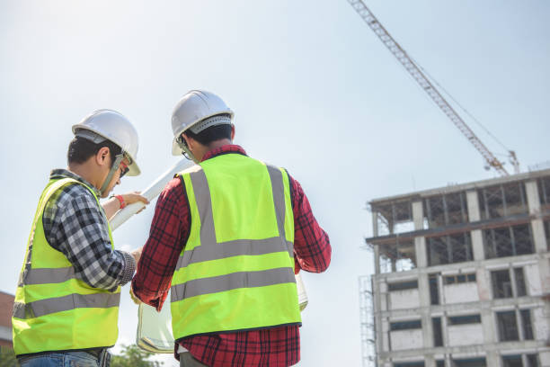 istock engineers discussion with surveyed about detail of building at construction site. 1341484790