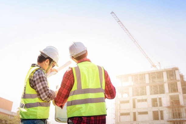 istock engineers discussion with surveyed about detail of building at construction site. 1341484811