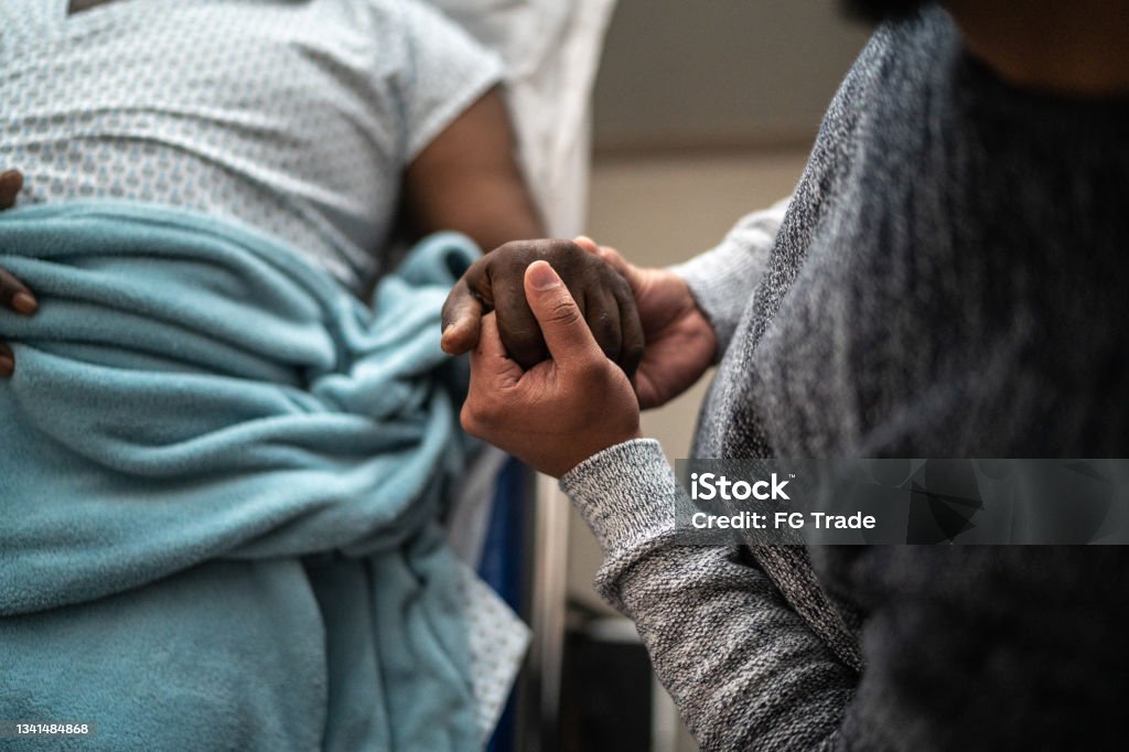 Son holding father's hand at the hospital Hospital Stock Photo