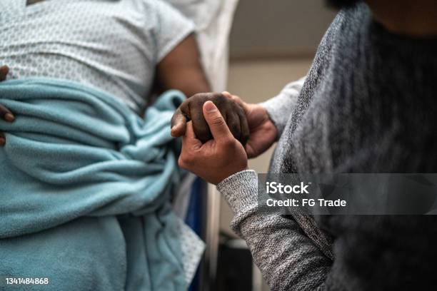 Son Holding Fathers Hand At The Hospital Stock Photo - Download Image Now - Hospital, Patient, Healthcare And Medicine
