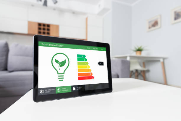 Energy efficiency mobile app on screen, eco house stock photo