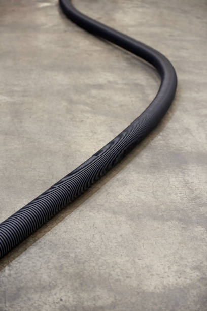 istock Corrugated plastic pipe for insulating electrical wires, on a concrete floor 1341489875