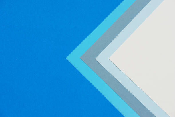 istock On a cobalt blue background, an abstract background concept with a geometric pattern in various hues of blue paper and white paper stacking. 1341493402