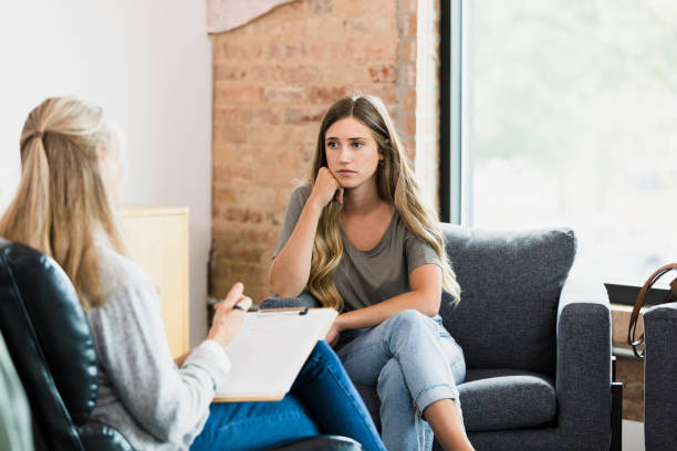 istock Young female client listens to unrecognizable counselor 1341502885