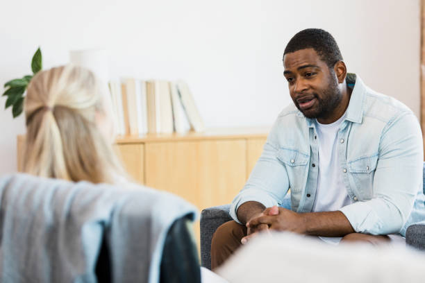 istock Emotionally distressed man talks to unrecognizable female therapist 1341502887