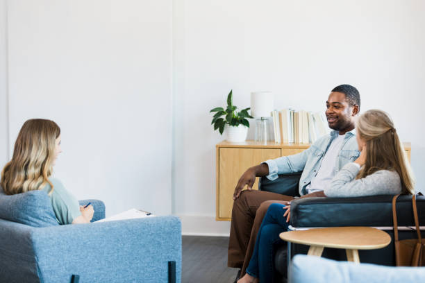 istock Diverse couple listens to female therapist 1341502896