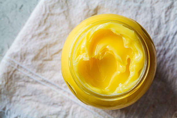 Ghee butter in glass jar, top view. stock photo