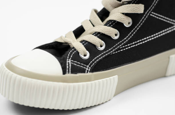 istock Close up of stylish black sneaker on white background, selective focus 1341505066