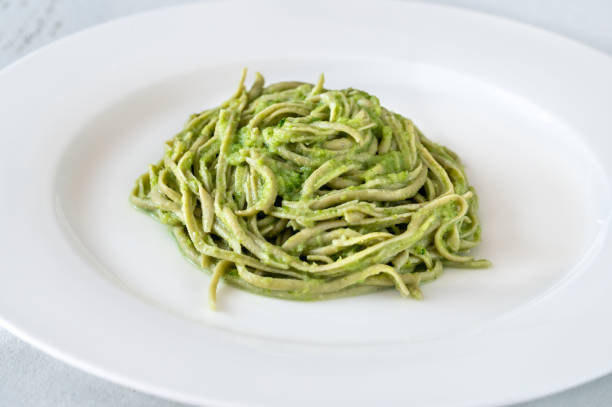 istock Green noodles with creamy sauce 1341506702