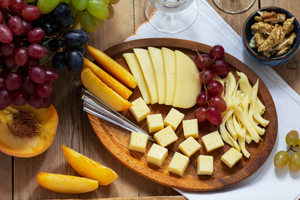 istock An appetizer of various types of cheese, grapes and walnuts, served with wine. Rustic style. 1341510253