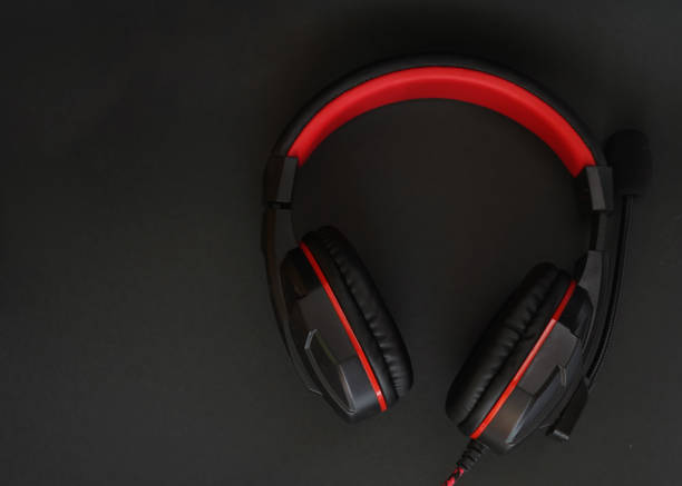 istock Black headphones with red stripes and a microphone on a black background 1341510615