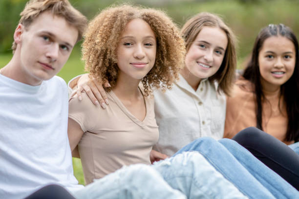 istock Teens Sitting in the Grass on Break 1341510638