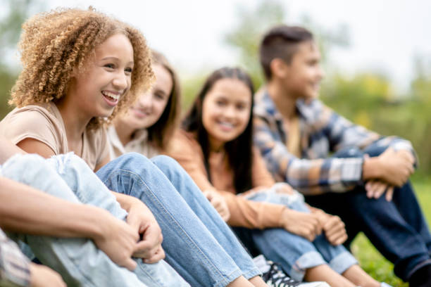 istock Multi-Ethnic High School Students Sitting Outside Laughing Together 1341510639
