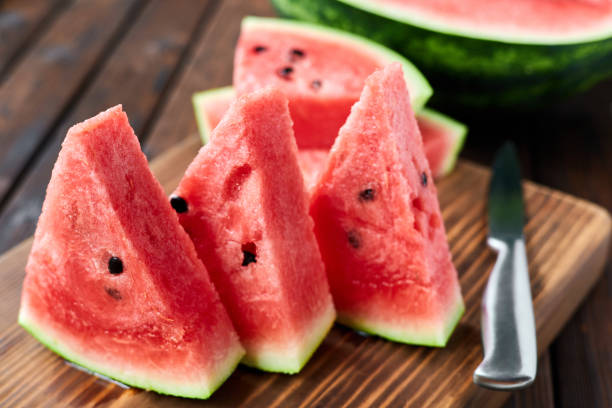 istock Sliced watermelon on brown wooden background. Close-up, selective focus 1341510671