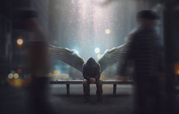 Angel all alone An angel sits on a bench as people pass by angel stock pictures, royalty-free photos & images