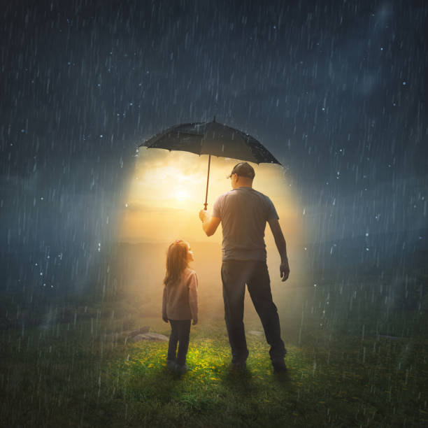 Father and Daughter in rain stock photo