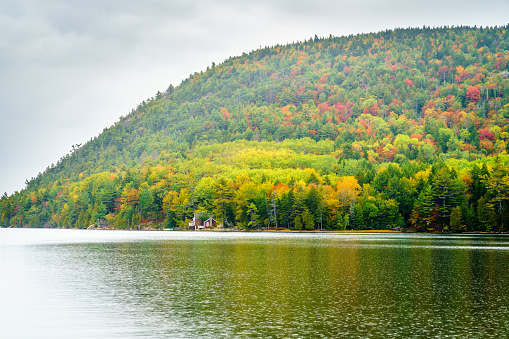Rockwood, Maine, USA - October 3, 2019: Daytime view of Mt kineo on Moosehead Lake during the autumn foliage season
