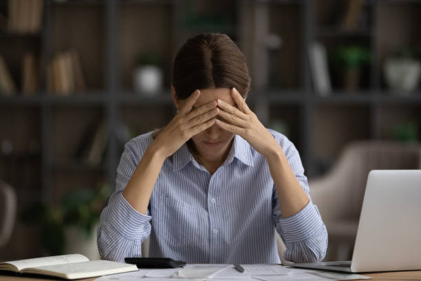 istock Depressed woman calculating bills, sitting at desk, financial problems 1341515867