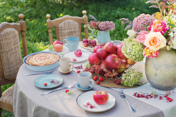 apple pie on laid table in  garden on sunny day