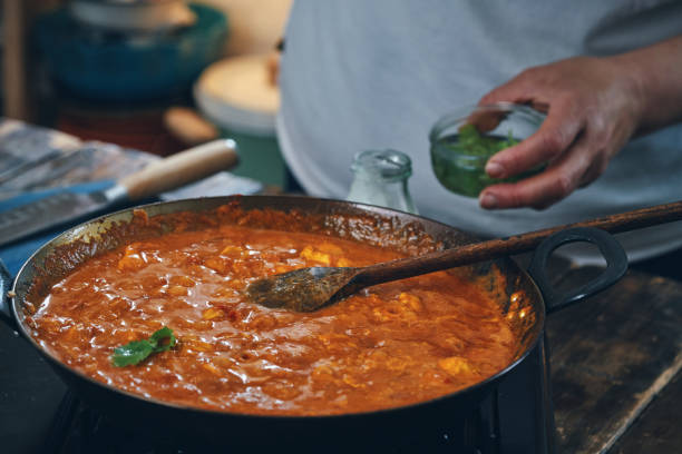 istock Preparing Indian Chicken Curry in Domestic Kitchen 1341519189