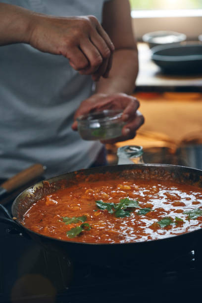 istock Preparing Indian Chicken Curry in Domestic Kitchen 1341519215