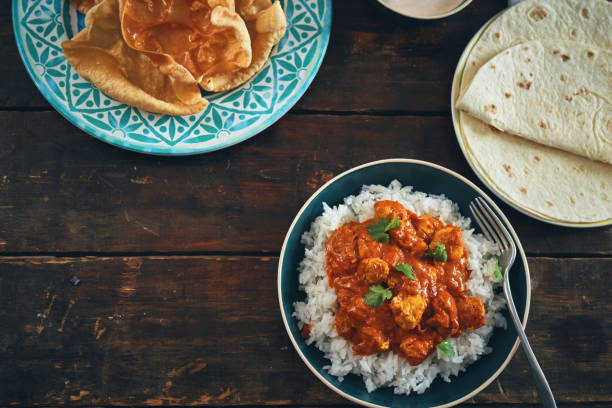 istock Indian Chicken Curry with Naan Bread and Pappadom 1341519823