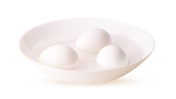 istock Three white raw eggs in a white plate in water 1341520489