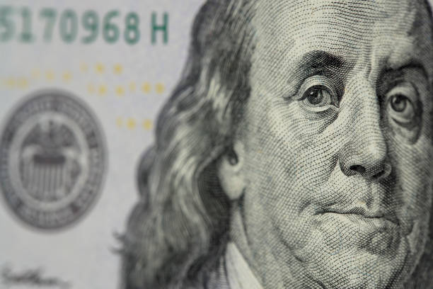 istock Benjamin Franklin on a US $100 banknote close-up 1341521801