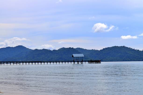 istock Small house and bridge on the sea 1341521939