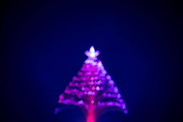 istock Christmas Tree (defocused) with Christmas bell shaped bokeh 1341522156