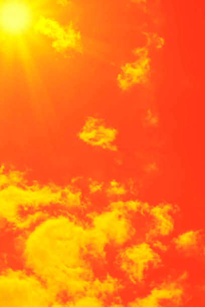 istock Bright sun with beautiful beams in the sky with clouds (toned in red) 1341522259