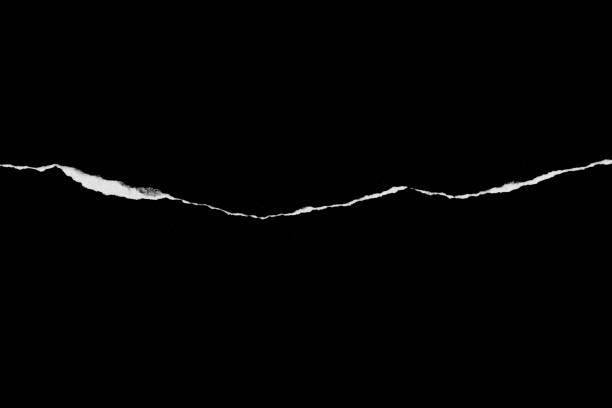 istock Ripped, torn paper edge isolated white on black, paper tear with space for copy 1341523772